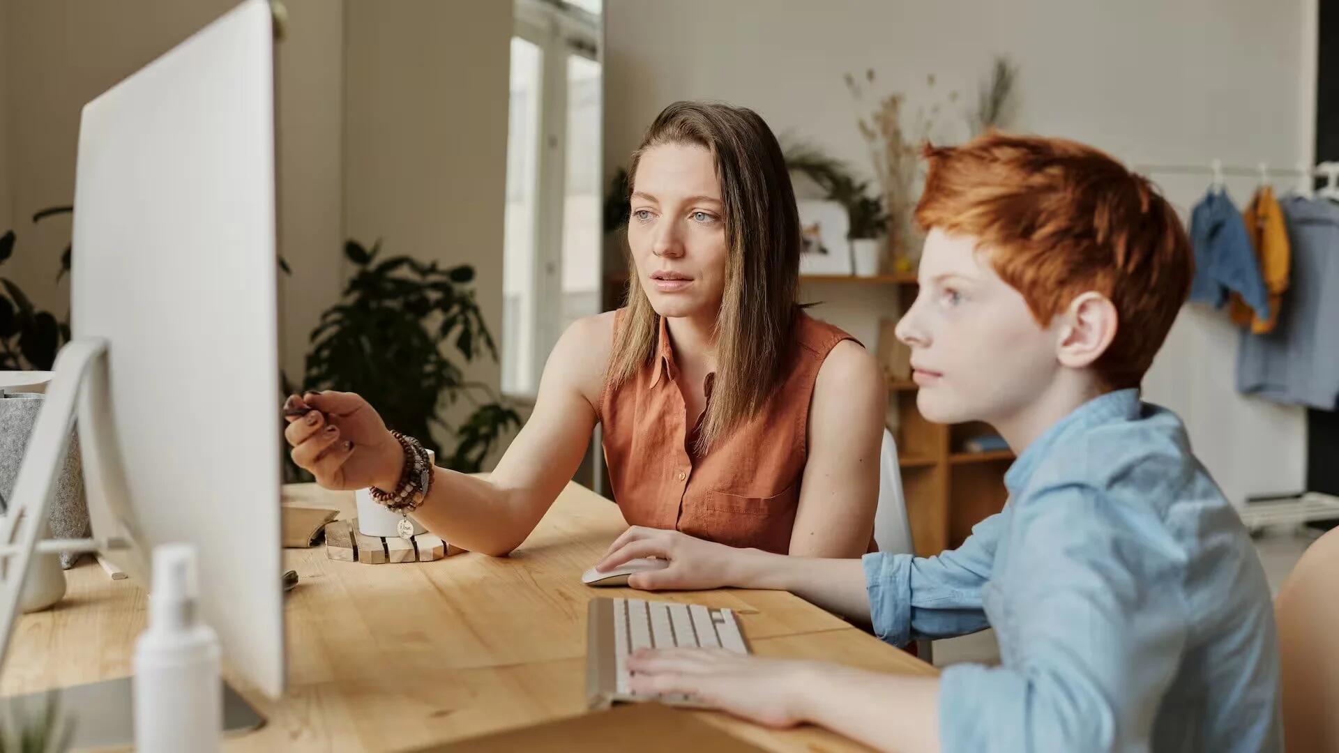 Woman tutoring a young kid